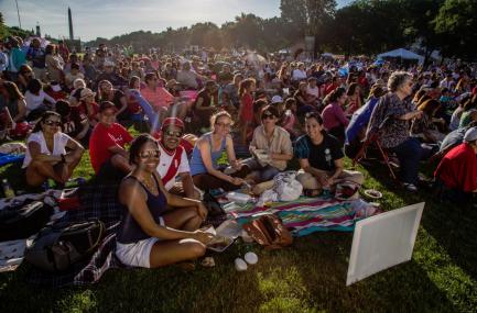 crowd sitting on the mall at sunset