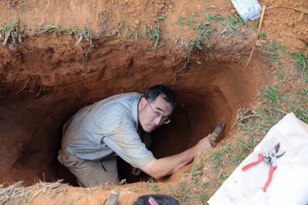 man digging deep into dirt