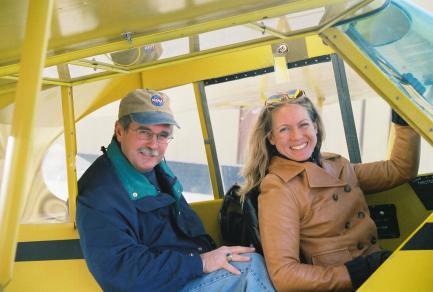 Father and daughter in cockpit of plane