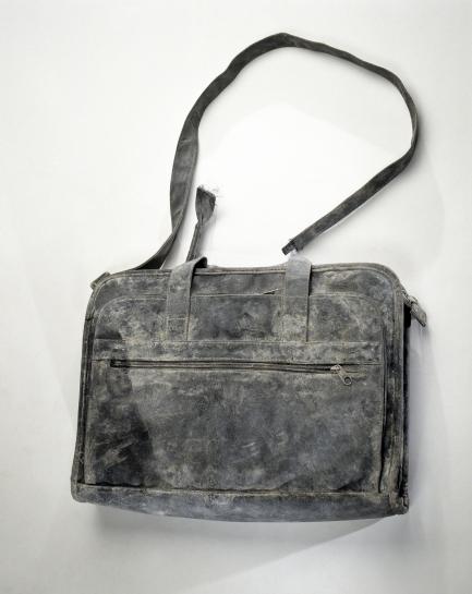 Battered black bag with shoulder strap