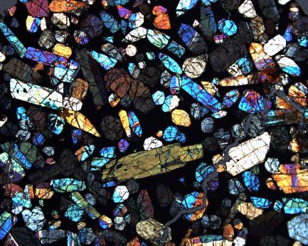 blue, orange, yellow, and cream colored coarse-grained minerals