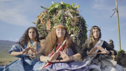 Polynesian women on catamarand, making prayerful gesture