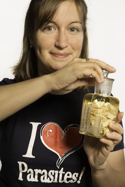 Woman holding specimen jar and smiling