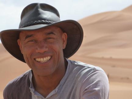 Casely-Hayford in the field, wearing hat
