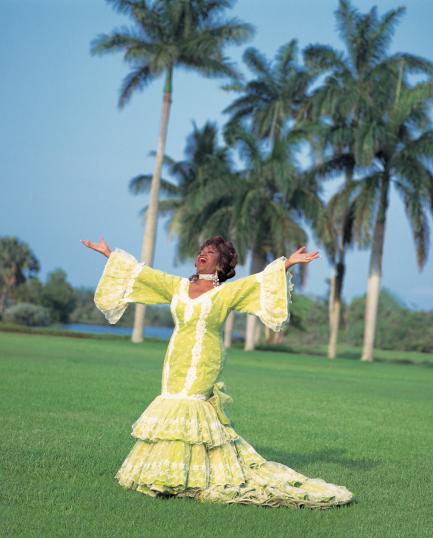 color portrait of Cruz in yellow flamenco dress