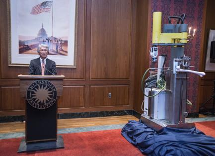 Think Surgical CEO at podium next to surgical robot