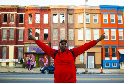 Man in red shirt with upraised arms